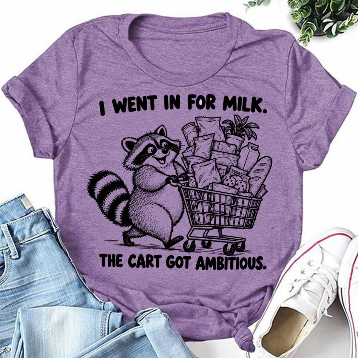 Purple women's T-shirt with I Went In For Milk. The Cart Got Ambitious graphic