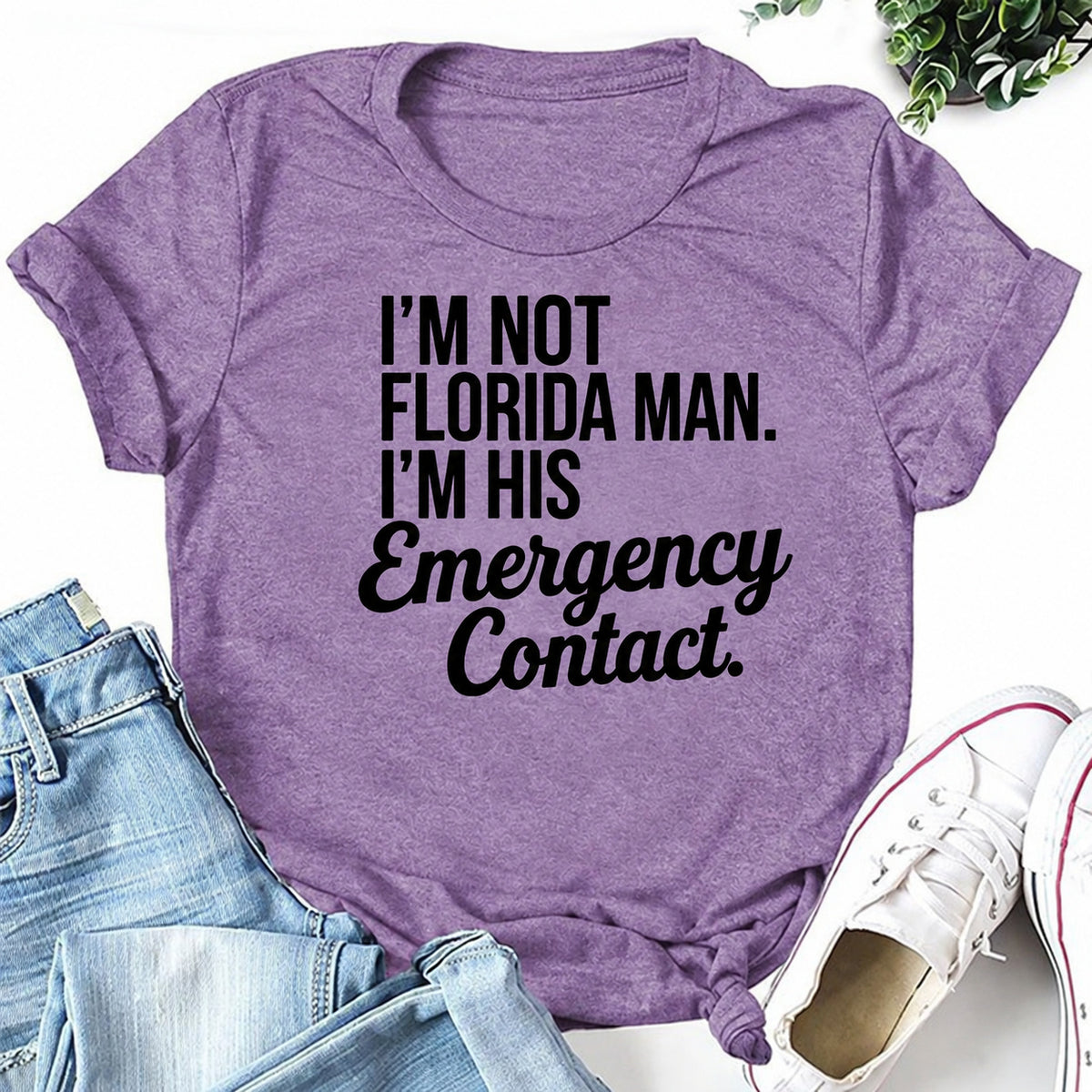 Purple women's T-shirt with I'm Not Florida Man. I'm His Emergency Contact graphic