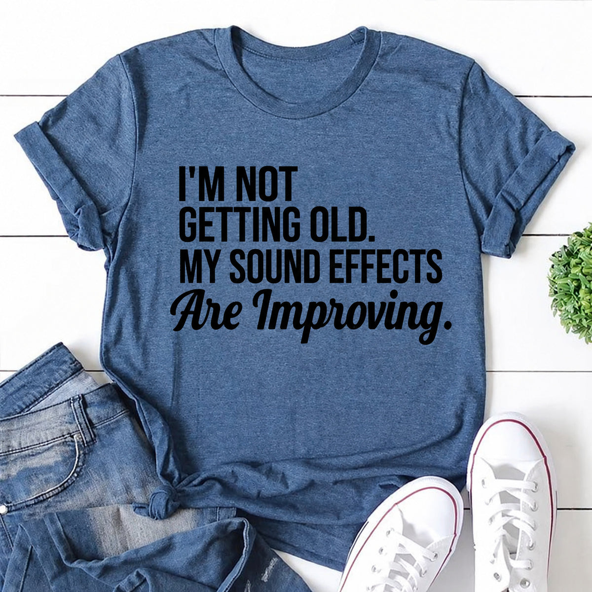 Blue women's T-shirt with I'm Not Getting Old. My Sound Effects Are Improving graphic