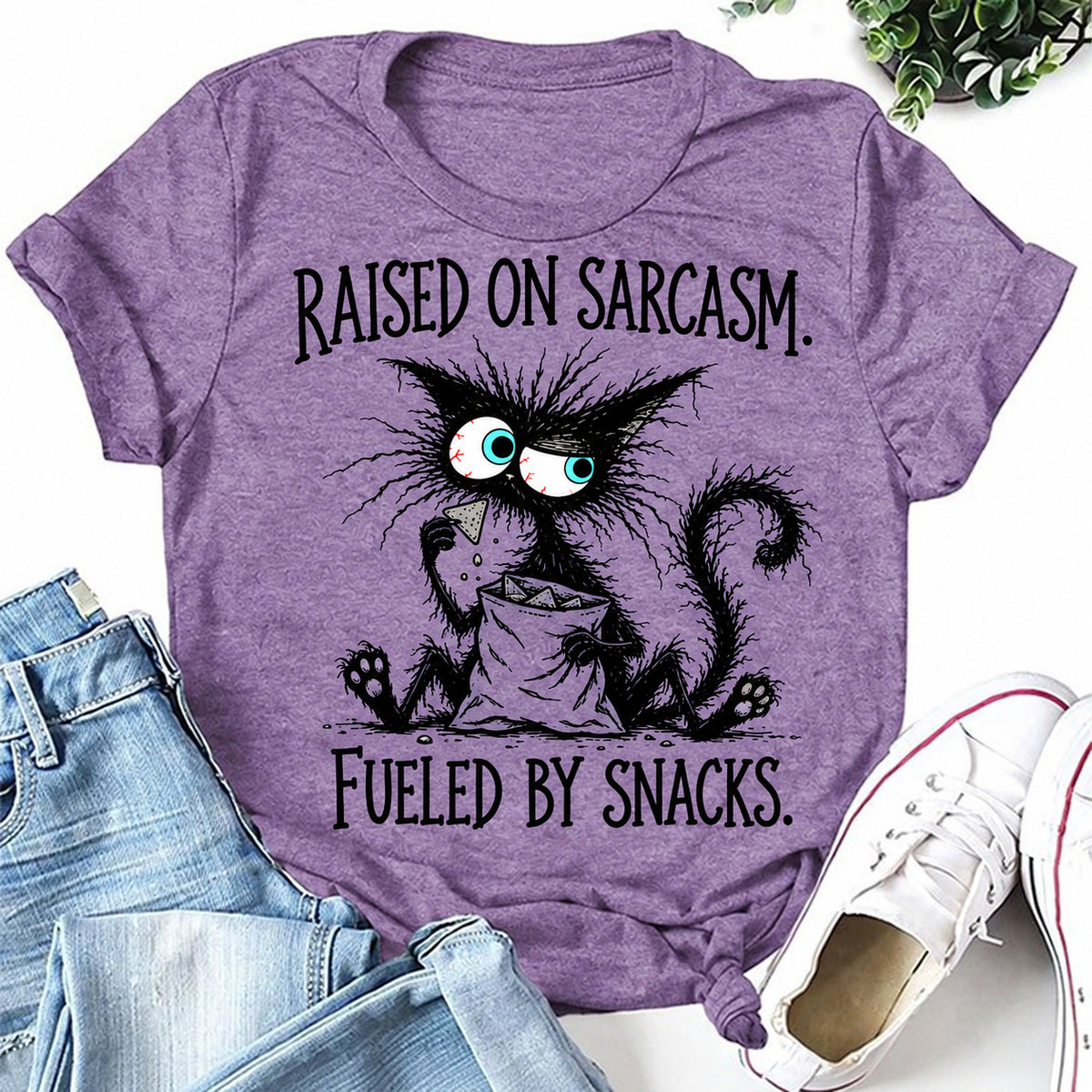 Purple women's T-shirt with Raised On Sarcasm. Fueled By Snacks graphic