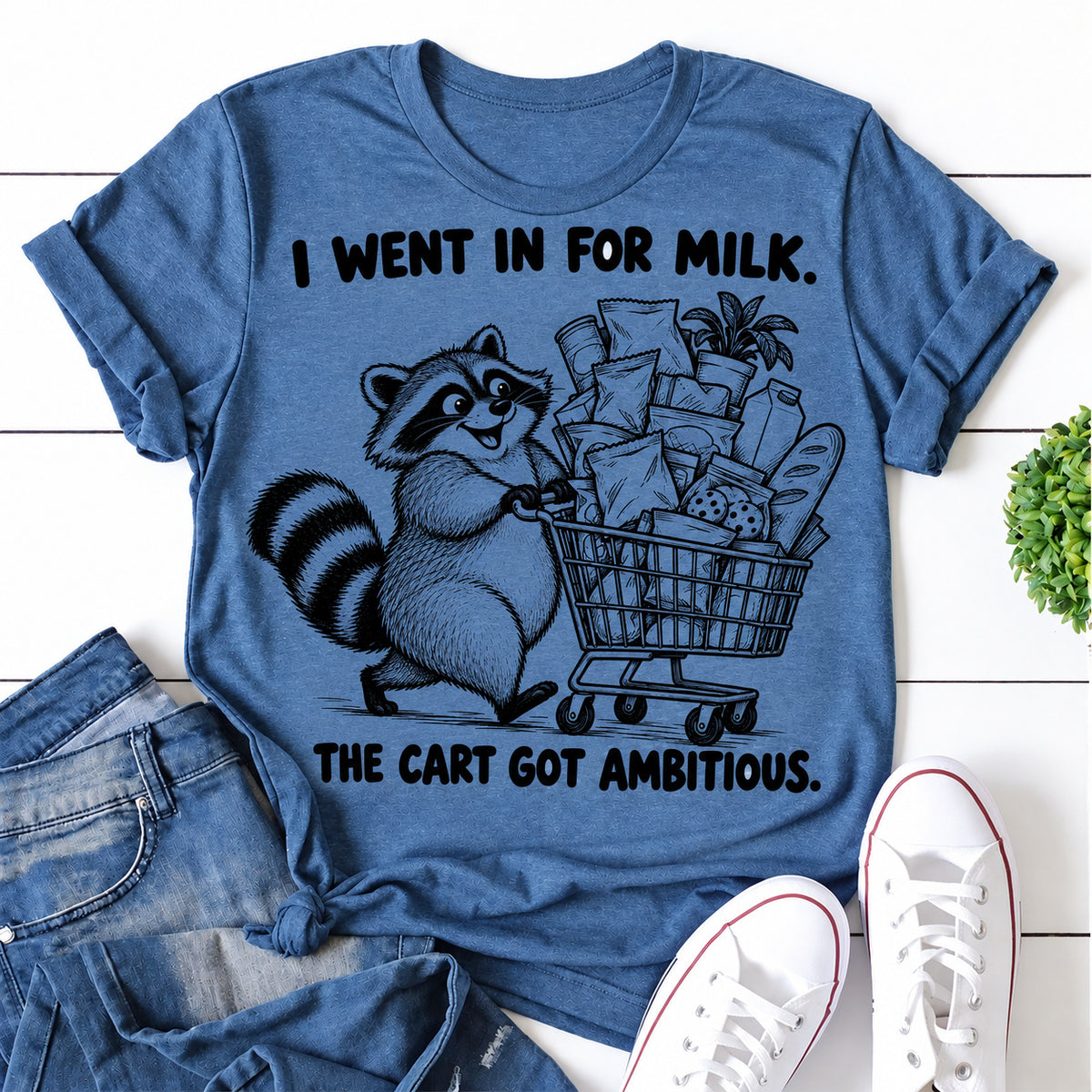 Blue women's T-shirt with I Went In For Milk. The Cart Got Ambitious graphic