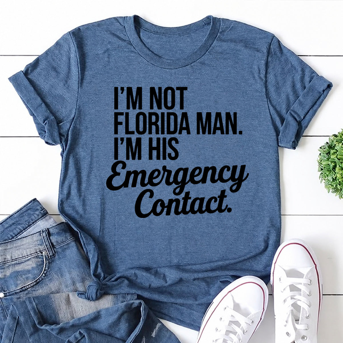 Blue women's T-shirt with I'm Not Florida Man. I'm His Emergency Contact graphic