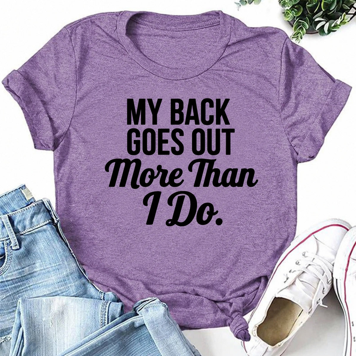 Purple women's T-shirt with My Back Goes Out More Than I Do graphic